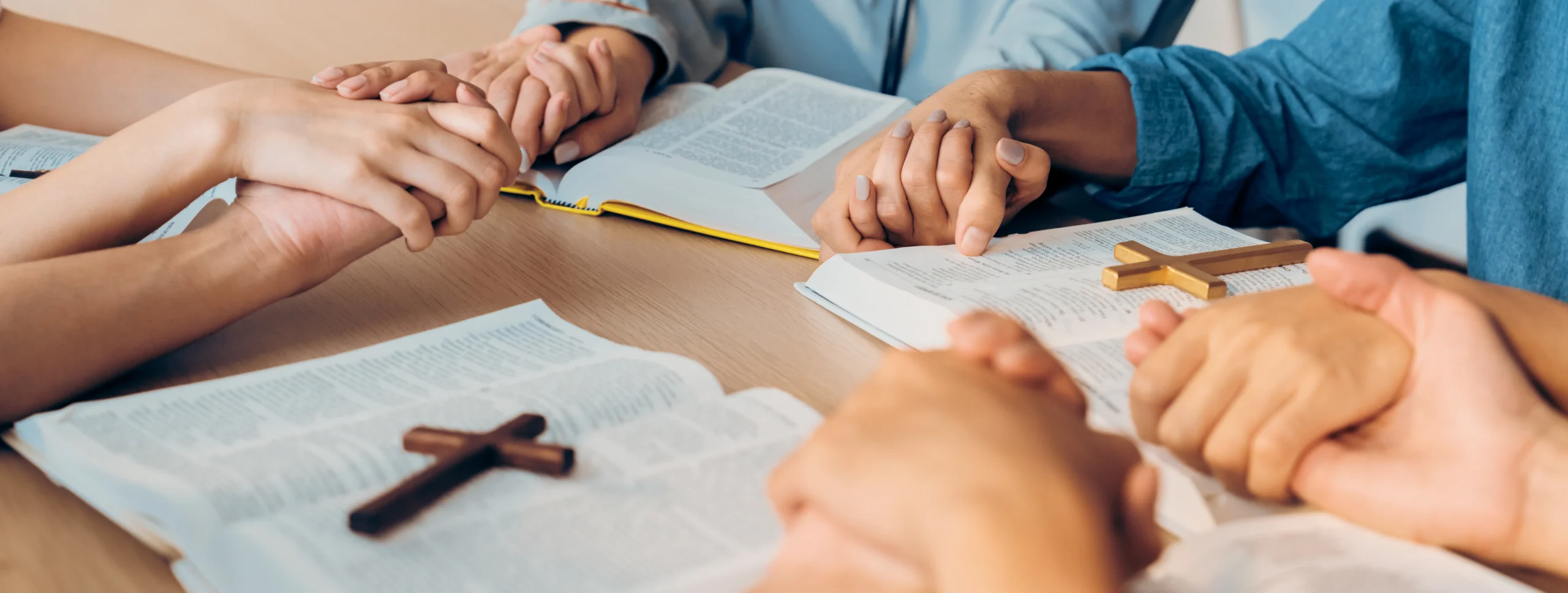 believer-hand-praying-together-bible-book-while-holding-hand-burgeoning