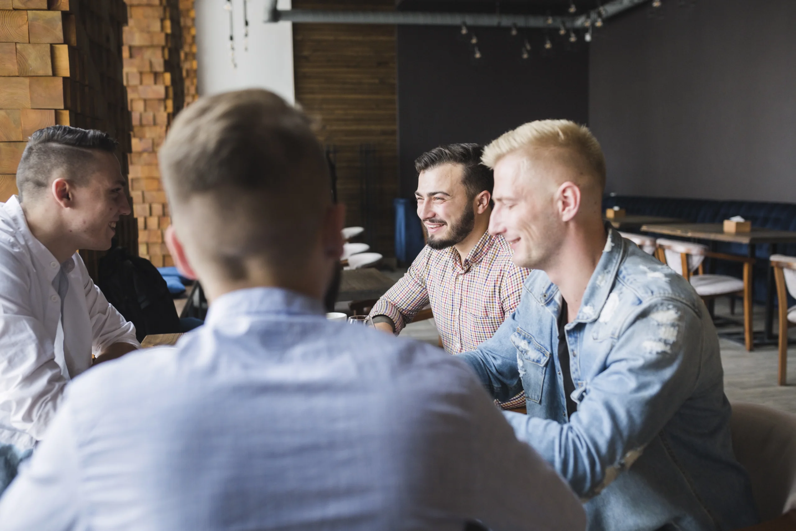 group-male-friends-sitting-restaurant