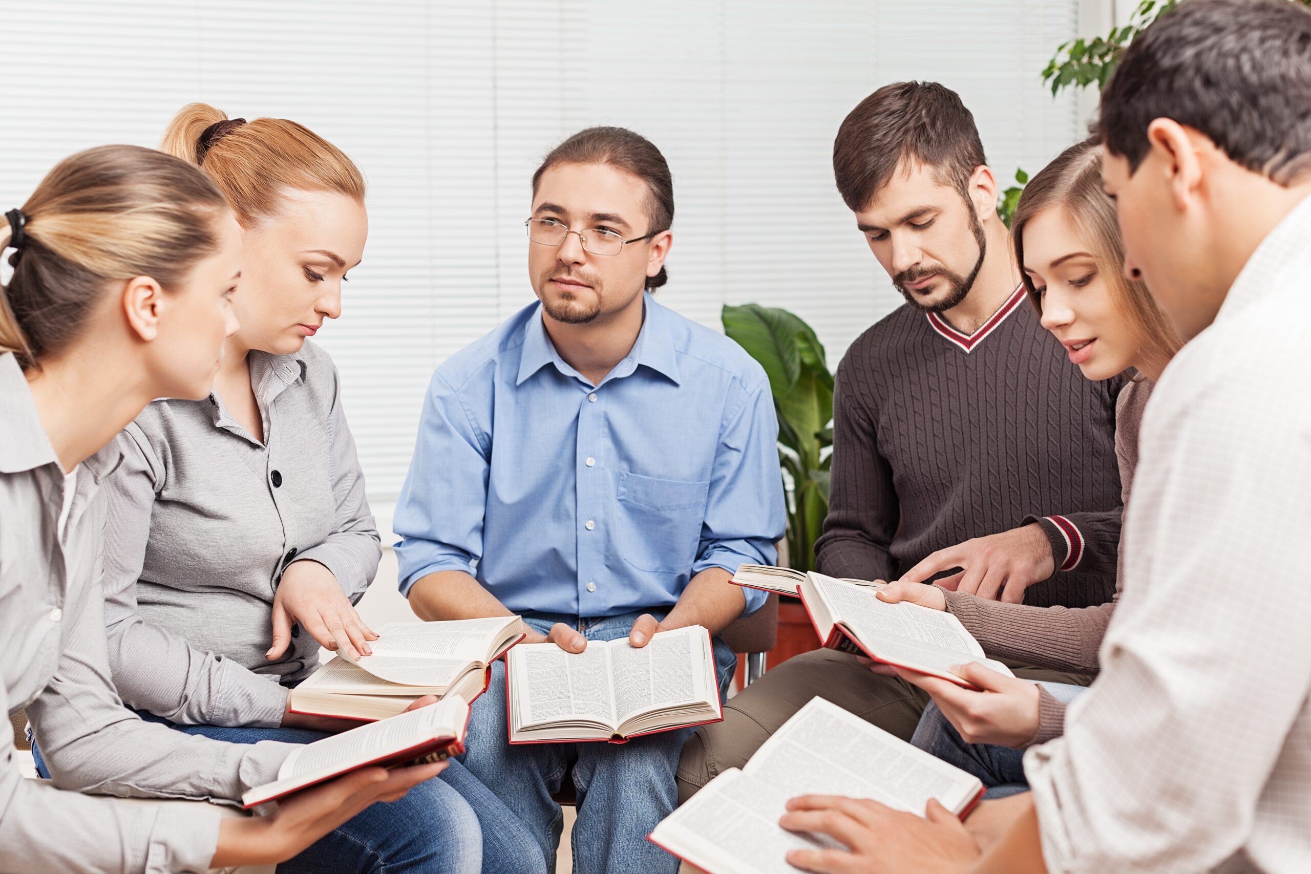 Group of people reading Bible book together