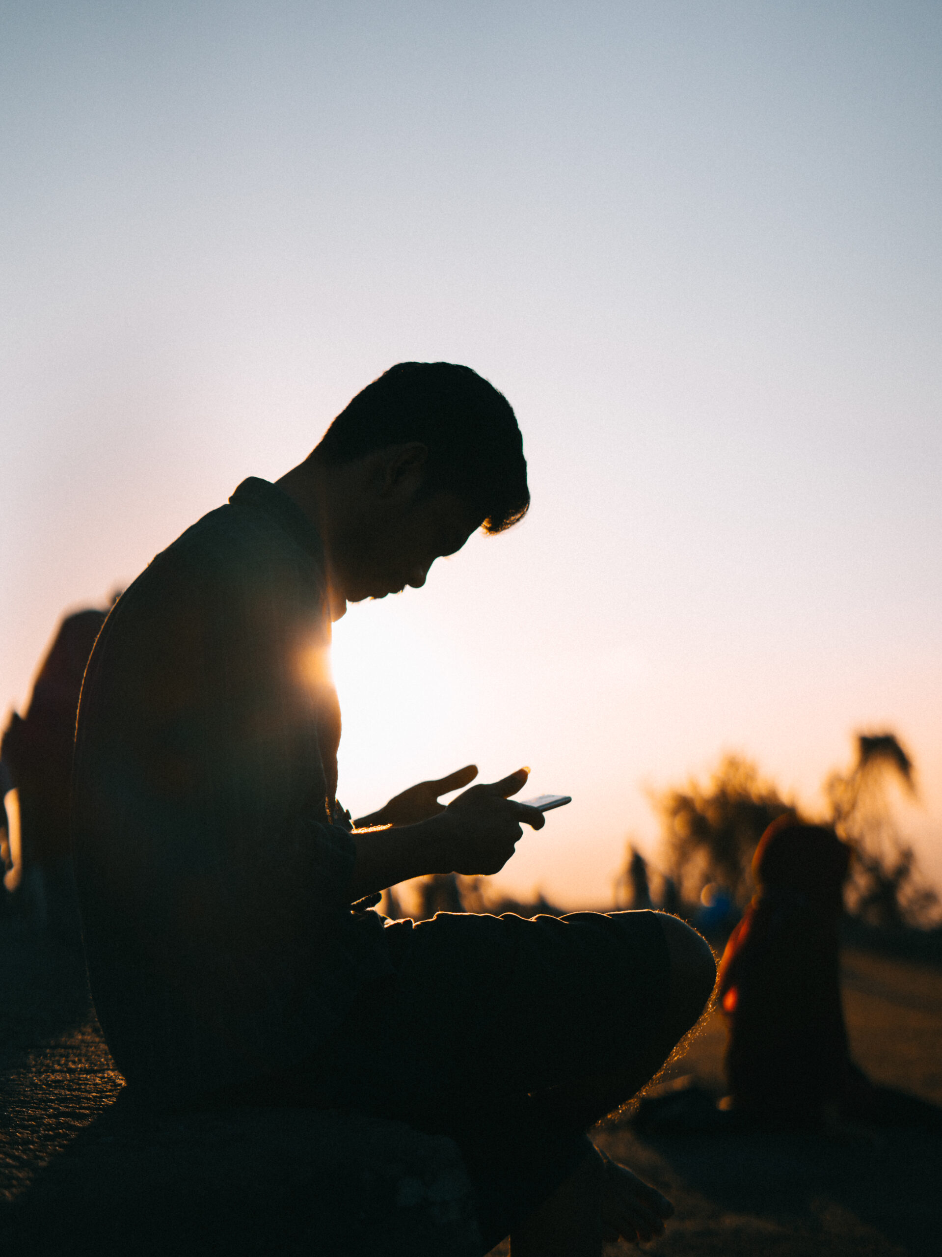 silhouette-man-with-his-phone