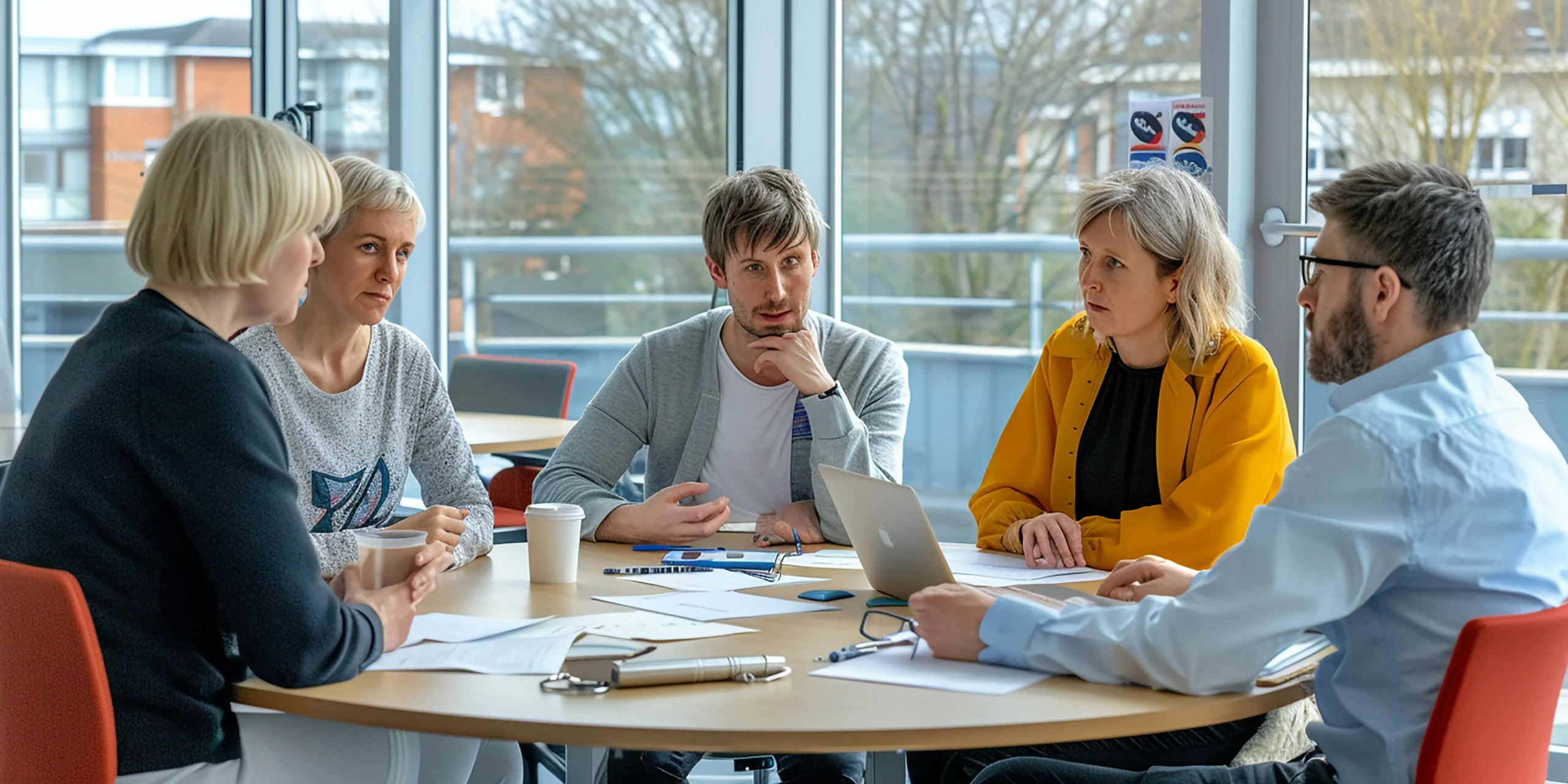 three-people-are-sitting-table-with-laptop-sign-that-saysthe-word-it